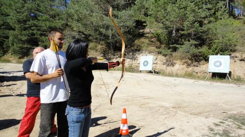 a man and a woman holding a bow and arrow at Rusaliite Adventure House in Bachevo