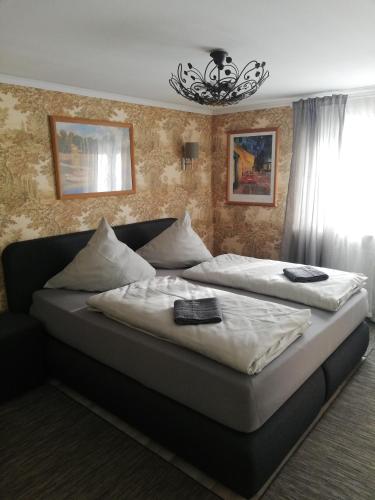 a bedroom with two beds and a chandelier at Eleonora Apartment in Winterberg