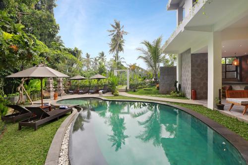 a swimming pool in the backyard of a villa at The Nani in Ubud
