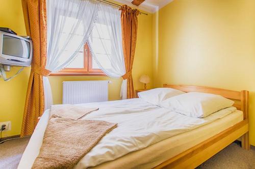 Postel nebo postele na pokoji v ubytování Karczma u Wallenroda