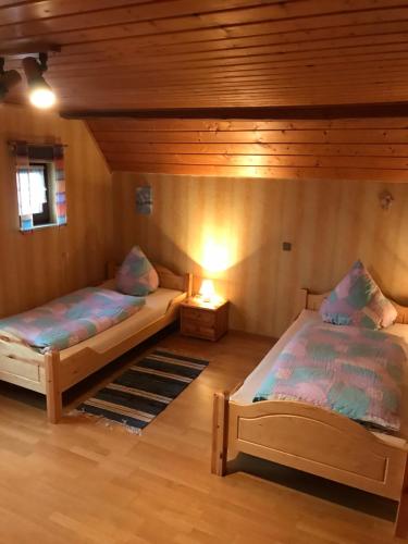 a room with two beds in a cabin at Urlaub auf dem Bauernhof Zeller in Wolframs-Eschenbach