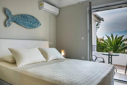 a bedroom with a bed and a large window at Julia's Luxury Suites #1 in Kástron