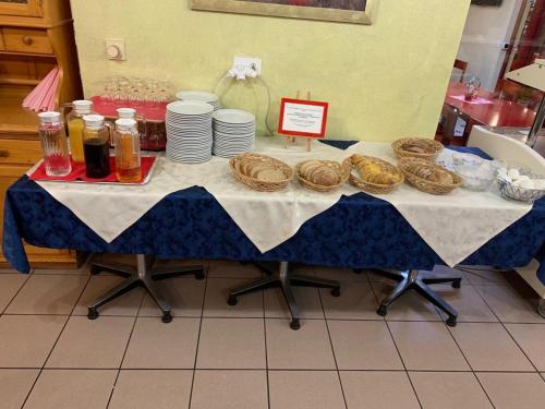 a table with plates and pastries on it at Hotel Lyssach in Lyssach