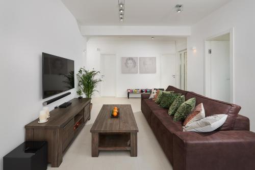 a living room with a couch and a coffee table at The White House, Brac in Pučišća
