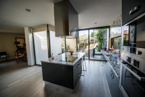 a kitchen with a sink and a counter top at Casa Foz do Corgo - private pool, gardens and river access in Peso da Régua