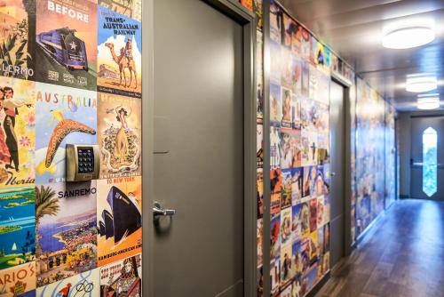 an elevator corridor with posters on the walls at HotelF1 Paris Saint Ouen Marché Aux Puces in Paris