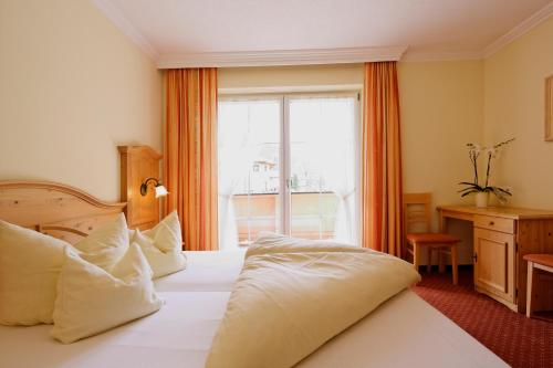 a hotel room with a bed and a window at Appartment Kinigadner in Pertisau