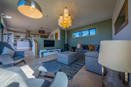 a living room with a couch and chairs and a tv at Oran Na Mara, Waternish in Hallin