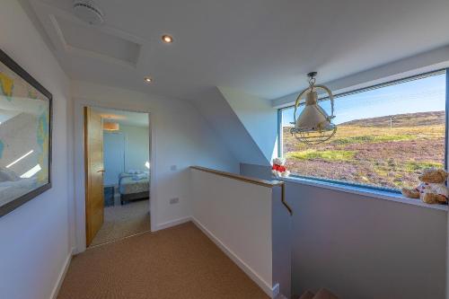 a hallway with a large window in a house at Oran Na Mara, Waternish in Hallin
