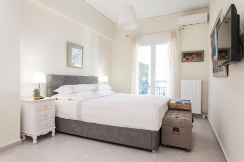a bedroom with a large bed and a tv at Athens Homes in Athens
