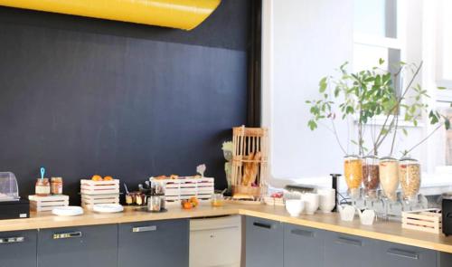 a kitchen with a counter top with oranges on it at Comfort Aparthotel Antibes Le Maestria in Antibes