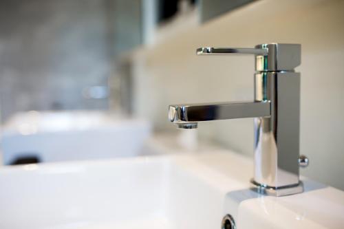a sink with a faucet in a bathroom at The Anda Mani Khaolak Beachfront Villas in Khao Lak