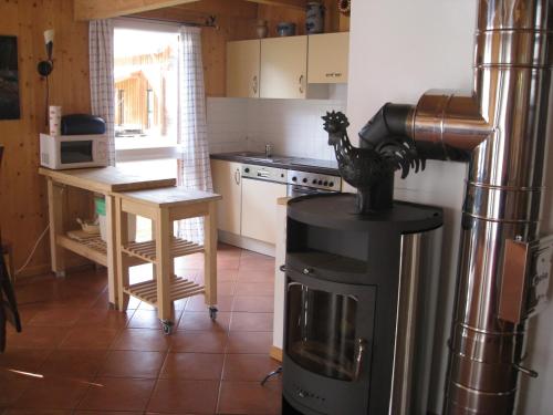 a kitchen with a stove and a table in it at Alpenferienhaus Kreischberg in Sankt Lorenzen ob Murau