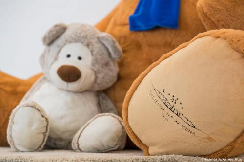 a stuffed teddy bear sitting next to a stuffed animal at Hacienda Na Xamena, Ibiza in Na Xamena