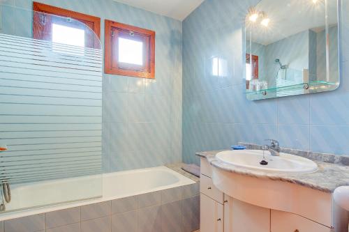 een badkamer met een wastafel en een bad en een wastafel bij Codonyer A in Port de Pollença