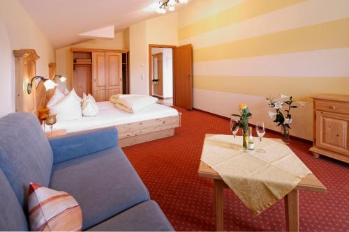 a hotel room with a bed and a table at Appartment Kinigadner in Pertisau