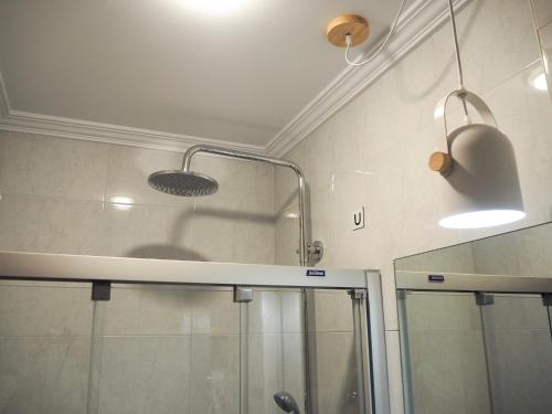a bathroom with a shower and a glass shower stall at Pensión Urkia in Donostia-San Sebastián