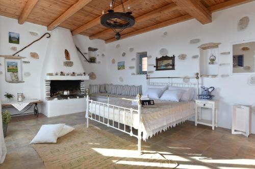 a bedroom with a bed and a fireplace at Eagles Nest in Angairiá