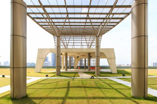 a view of a large white building with columns at Encorp Strand Residences by Airhost in Kota Damansara