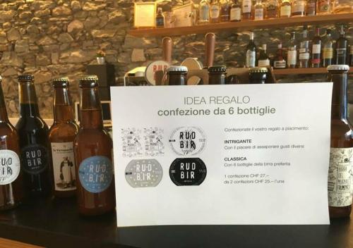 a sign in front of some bottles of alcohol at Bed&Bike Tremola San Gottardo in Airolo