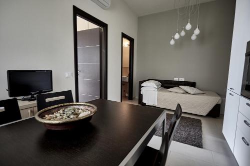 a living room with a table and a bedroom at Rouge Hotel International in Milano Marittima