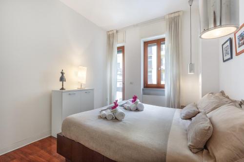 ミラノにあるBright and Cozy Apartment in Isola District - Marco Poloのベッドに座った動物2匹の姿見が付いたベッドルーム
