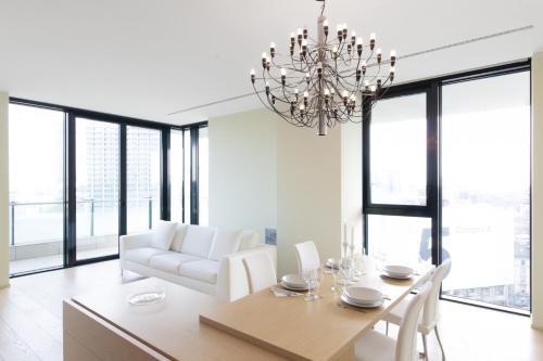 ミラノにあるStylish elegant Suite in Torre Solaria with exclusive Milan's viewのダイニングルーム(テーブル、椅子、シャンデリア付)