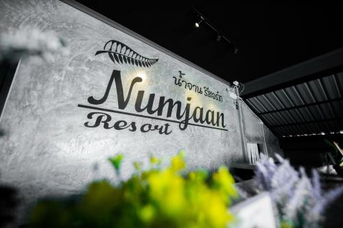 a sign for aulum restaurant on a wall at Numjaan Resort in Krabi town