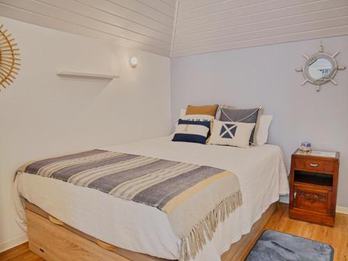 una camera da letto con un letto grande con cuscini sopra di Casa do pescador a Machico