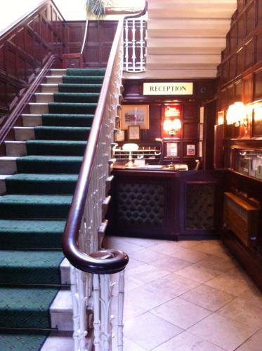 a staircase in a building with a stair case at Georgian House Hotel in Derby