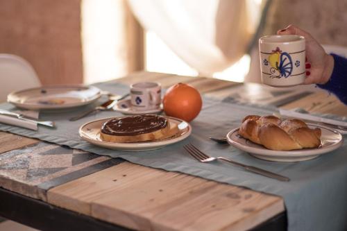 a table with plates of pastries and a cup of coffee at Cece Nove - Sotto l'Arco in Rutigliano