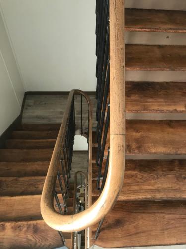 a wooden spiral staircase with a metal railing at Residence Hoche in Le Pré-Saint-Gervais
