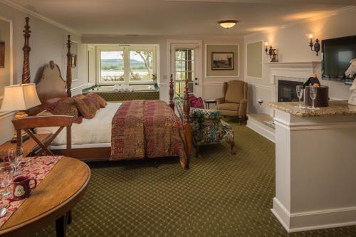 a hotel room with a bed and a fireplace at Goldmoor Inn & Resort in Galena
