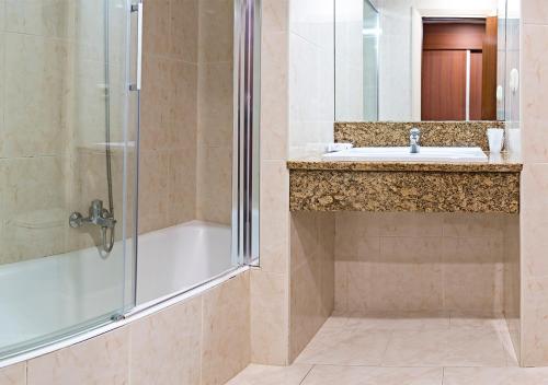 a bathroom with a shower and a sink at Hotel Txartel in Lasarte