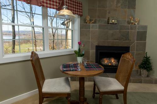 a dining room with a table and a fireplace at Goldmoor Inn & Resort in Galena