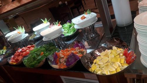 a buffet of different types of vegetables in bowls at Violet Al Azizia Hotel MASJID Al Qatari in Makkah