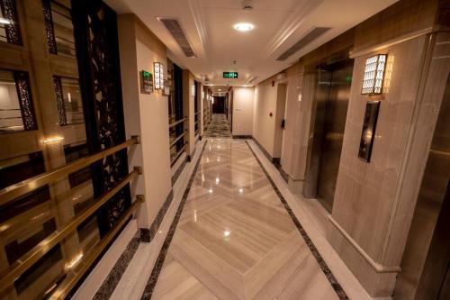 a hallway of a building with a shiny floor at Violet Al Azizia Hotel MASJID Al Qatari in Makkah