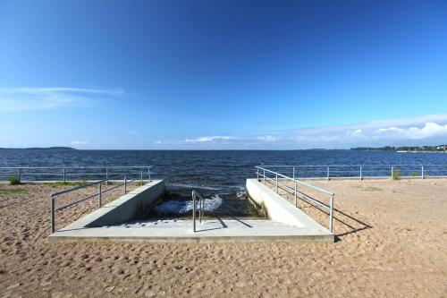a concrete staircase on a beach next to the water at Hotel Badehaus Goor in Putbus
