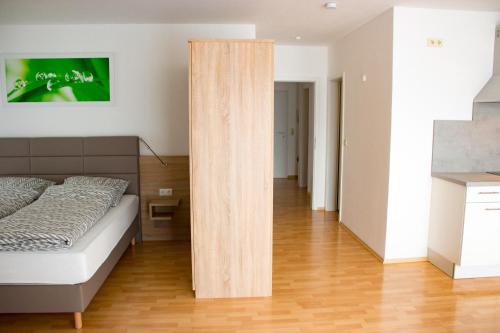 a bedroom with a bed and a wooden partition at Espelkamp Gästehaus in Espelkamp