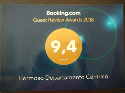 una señal para los premios de revisión de invitados con un círculo amarillo en Hermoso Departamento Céntrico en Villa Carlos Paz