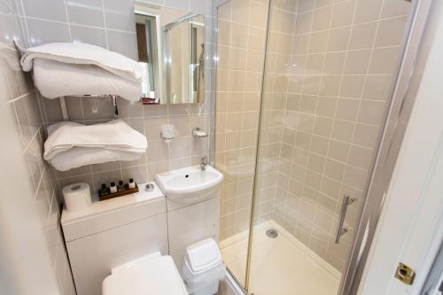 a bathroom with a shower and a toilet and a sink at The Queens Hotel in Lytham St Annes