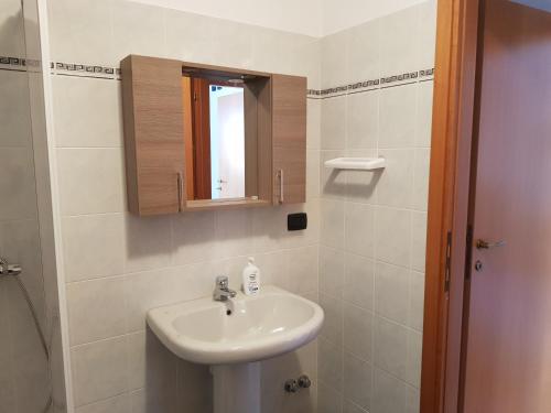 a bathroom with a sink and a mirror at Casa Sabrina in Aprica