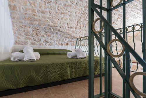 a room with a bed with towels on it at White Stone Flats & Studios in Ostuni