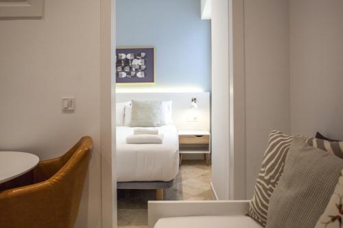 a small room with a bed and a desk at Gran Central Suites in Madrid