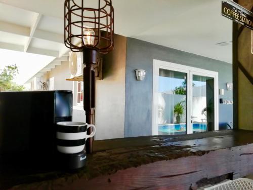 a table with a coffee mug on top of it at Studios 11and11Aruba in Palm-Eagle Beach