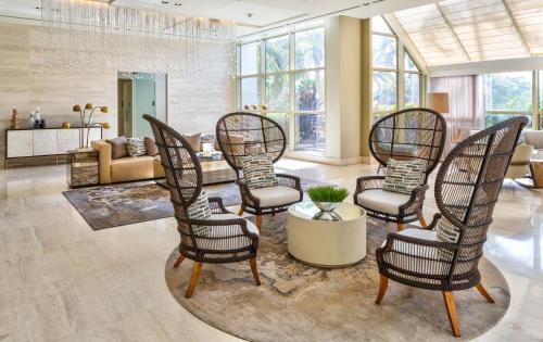 a group of chairs in a living room at Naples Grande Beach Resort in Naples