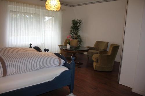 a bedroom with a bed and a table and a chair at Sohre in Hamburg