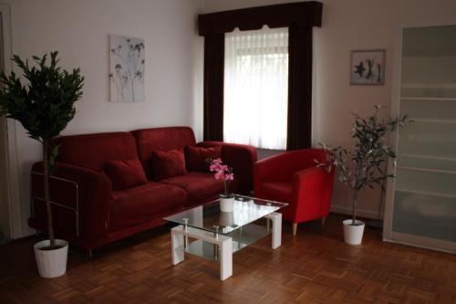 a living room with a red couch and a coffee table at Sohre in Hamburg
