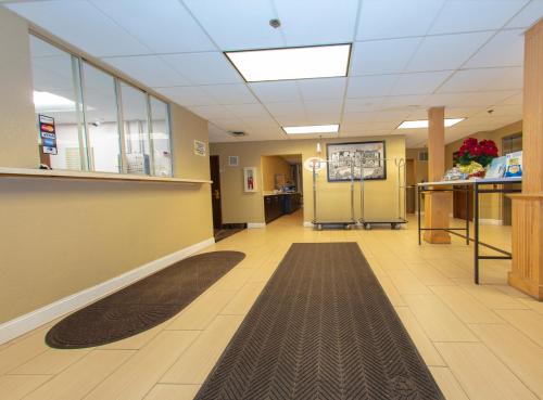a hallway of a hospital with a rug on the floor at Super 8 by Wyndham St Charles in St. Charles