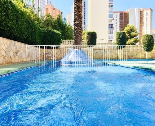 a swimming pool with a fountain in a city at Edificio Cadiz Benidorm in Benidorm